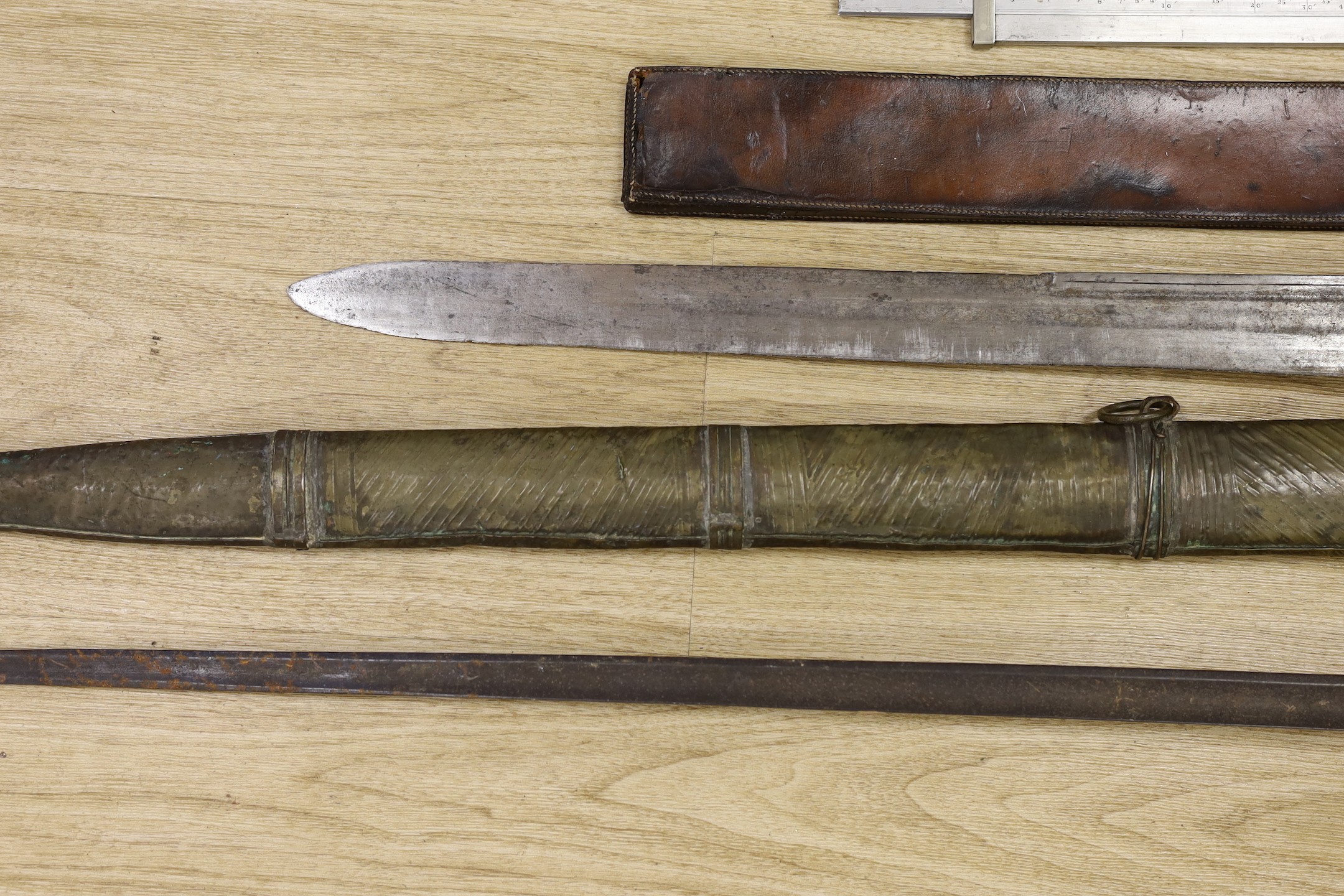 A Moroccan nimcha sword with associated Andrea Ferrara (Scottish) blade and a scabbard together with a court sword and an Aston & Mander Ltd. Mk VI military rule in leather case